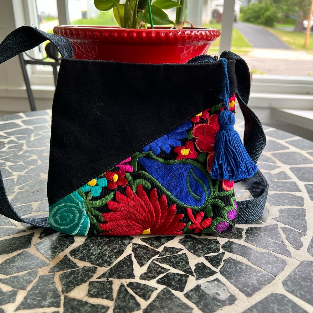 Small Mexican embroidered crossbody bag. Black and blue denim accents the flower